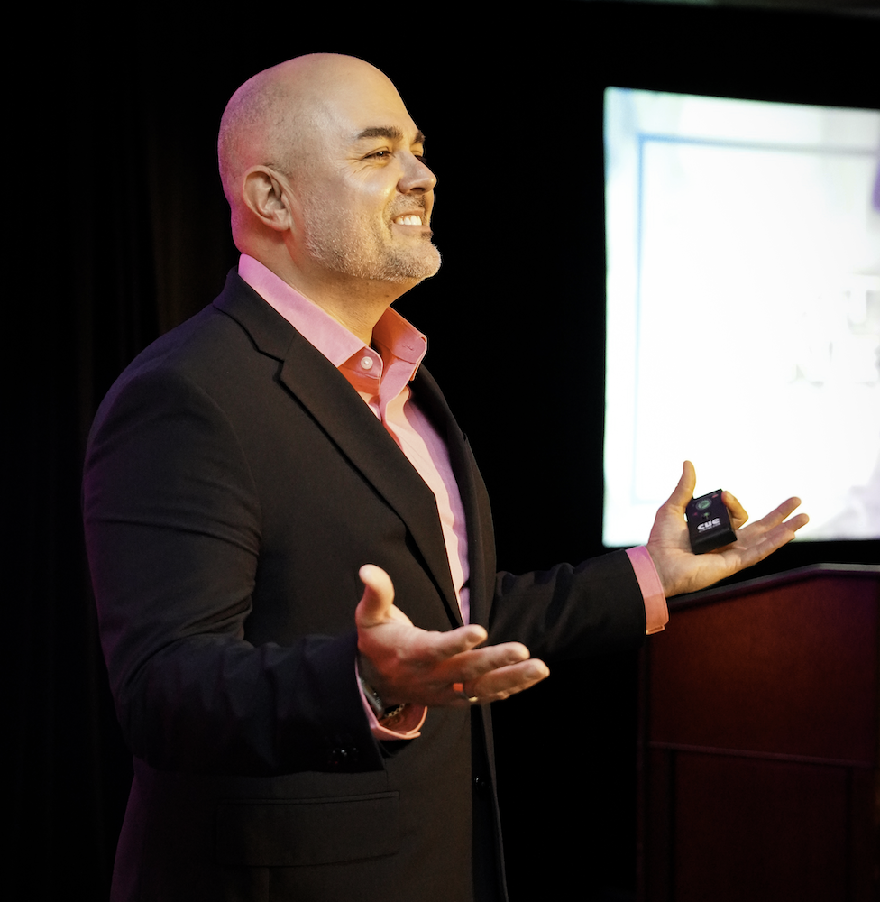 Armando Leduc presenting on stage